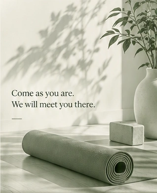 A sage yoga mat and blocks in soft sunlight. Come as you are. We will meet you there.